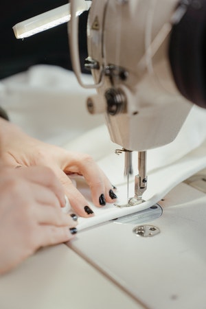close view of woman stitching 