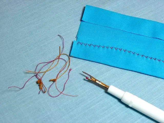 seam ripper with piece of paper