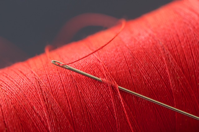 red thread and sewing needle