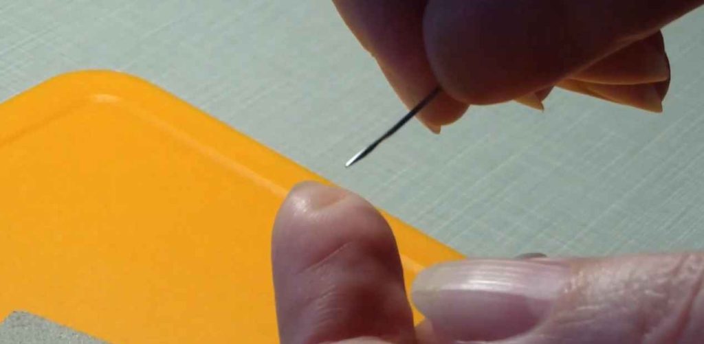 checking sewing needle using hands