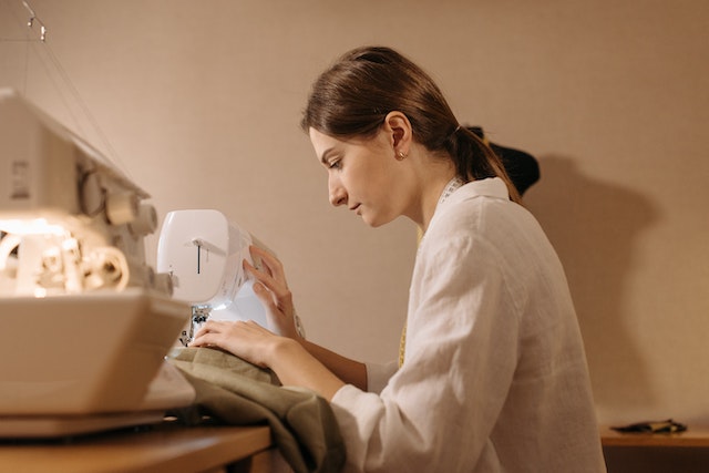 woman sewing something on sewing machine